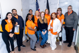 Group on NKF advocates posing with congress aid