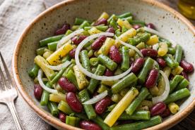 Three bean salad with green beans, wax beans, kidney beans, onion, and tangy vinegar dressing