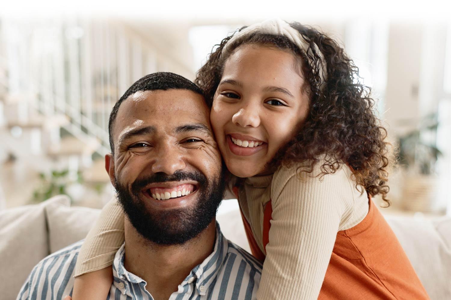 daughter hugging her father on the couch