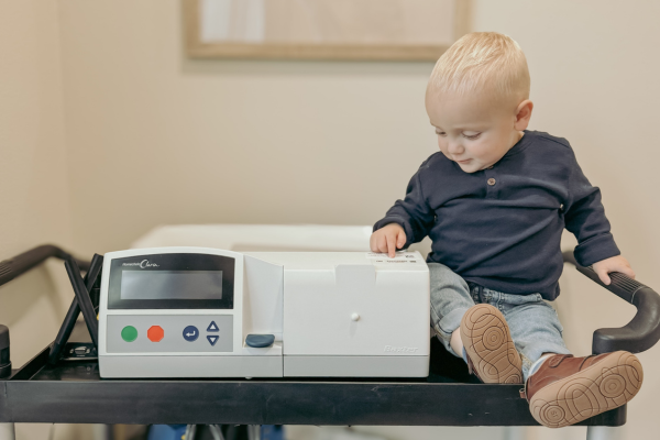 Sully Ransome sitting next to home dialysis machine.