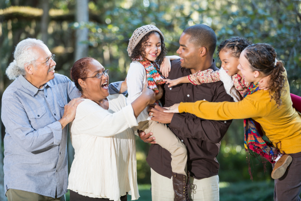 Family laughing together outside