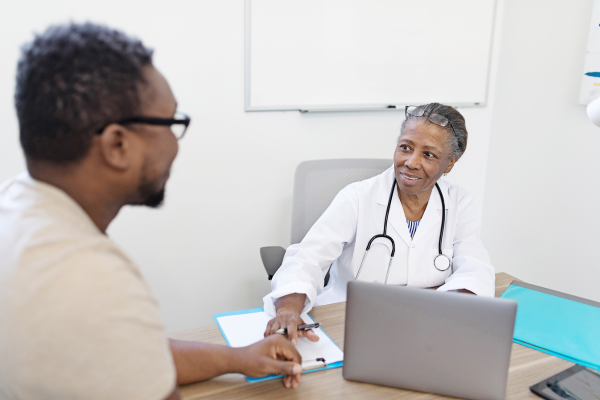 Doctor and patient speaking in office