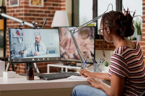 Patient at home speaking with doctor over computer.