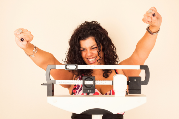 Person celebrating on weight scale