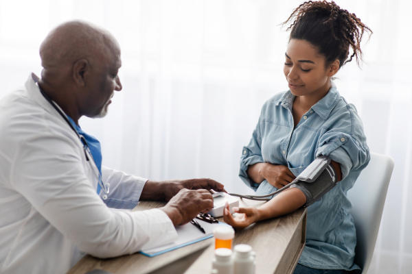 Doctor testing patient's blood pressure