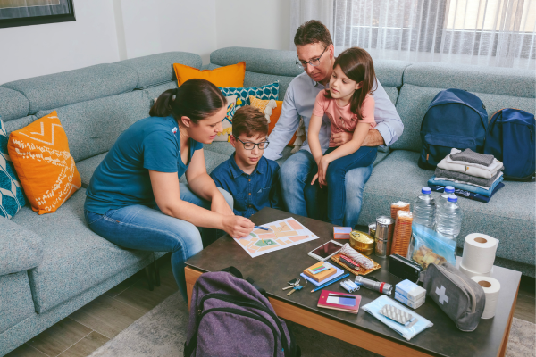 Family of four in living room going over emergency plans