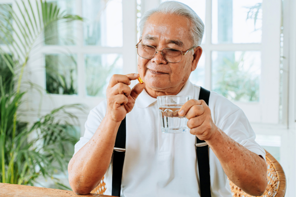 Older person taking a pill