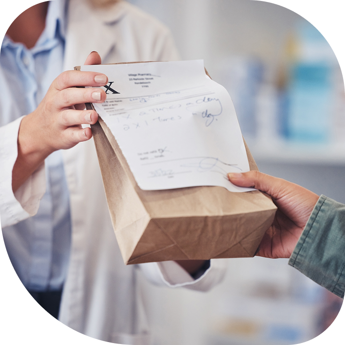 pharmacist handing a person their prescription