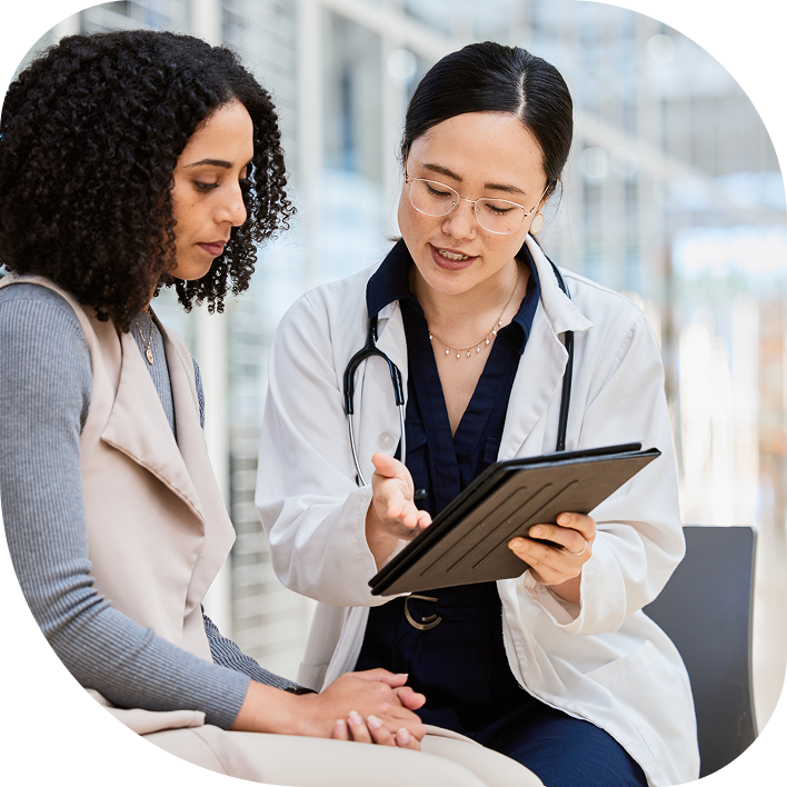 Medical professional speaking with patient, reviewing guidance