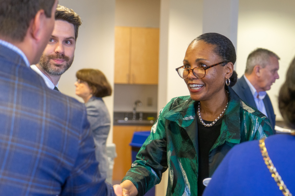 Dr. Ebony Boulware shaking hands with other professionals