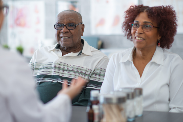 Patient and caregiver speaking with a doctor