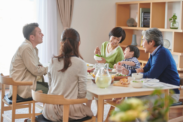 Parents and grandparents having meal with child