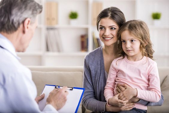 kid with mom talking to doctor