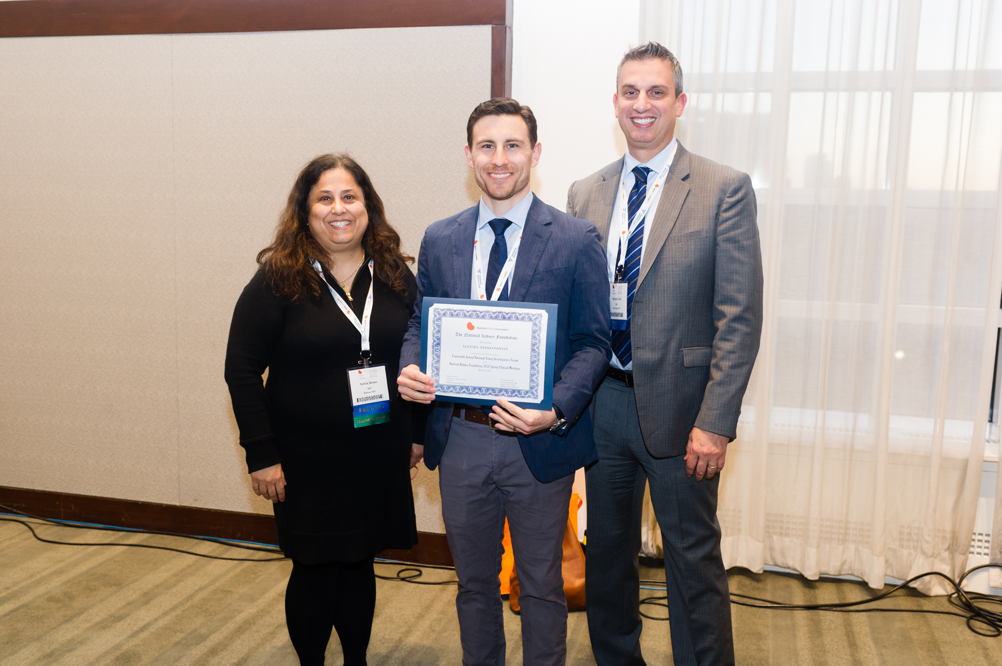 Dr Daniel Edmonston receiving the 2nd Place Young Investigators Forum Award with two representatives of the National Kidney Foundation