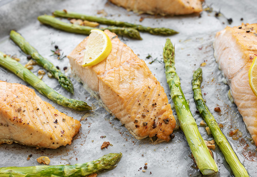baked salmon and asparagus on a sheet pan with lemon