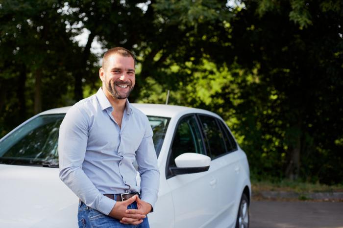 guy leaning to his car 