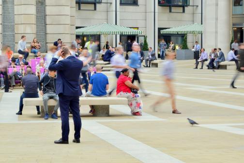 man-wearing-blue-suit-on-beige-ground-near-building.jpg