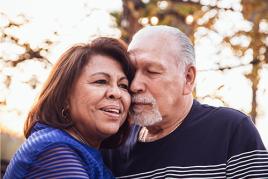 Older couple cuddling outside