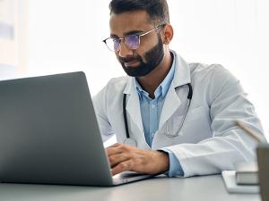 Doctor watching a educational video on a laptop
