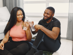 two people toasting with glasses of water