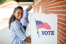 Person smiling at voting booth