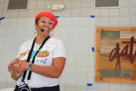 Angelique smiling and leading an art class