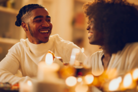 Couple happily enjoying candlelight dinner