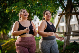 Two people happily walking together outside