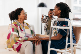 Child and grandchild having a nice visit with elderly family member