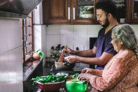 Grandchild and grandparent cooking together