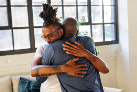 Two adults embracing each other