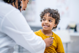Smiling child getting heart beat taken