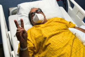 Orlando A. Torres Meléndez giving peace sign after transplant