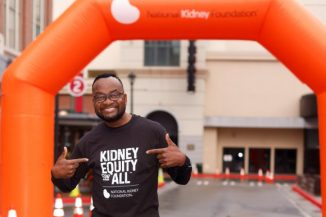 Anthony Tuggle pointing to Kidney Equity for All t-shirt at Kidney Walk