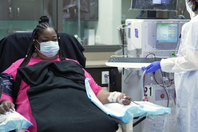 Person receiving dialysis treatment in center