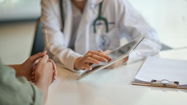 Doctor showing a patient information on a tablet