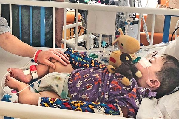 Baby Lockett in a hospital bed after receiving a kidney transplant from his mom