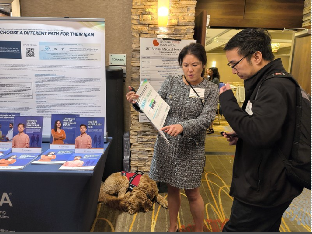 Photo of attendees at booth at 56th Annual Medical Symposium