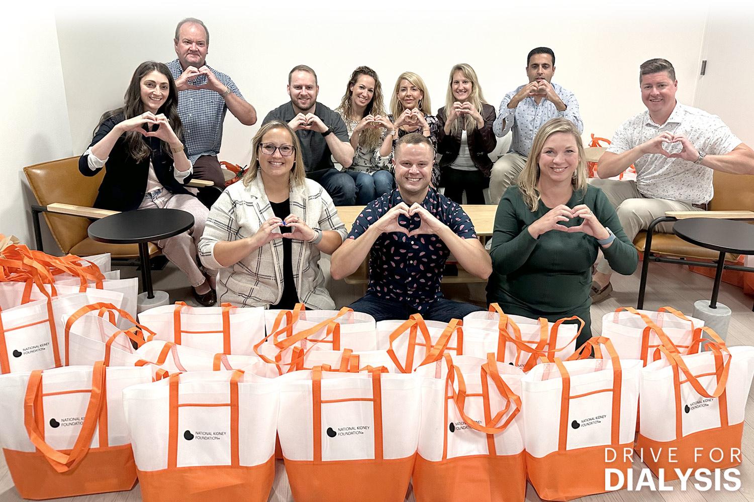 Group of people who participated in Drive for Dialysis, posing together with the bags they assembled