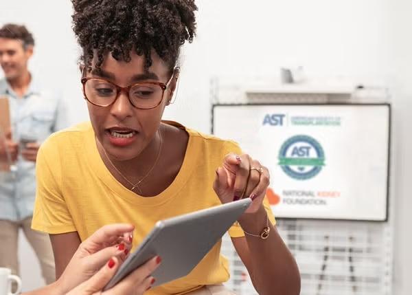 A woman viewing and pointing at iPad