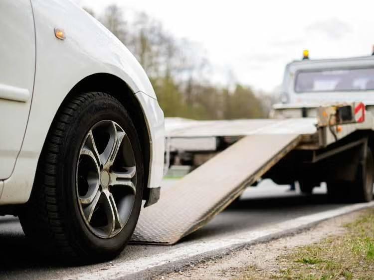 A white car moving towards a truck
