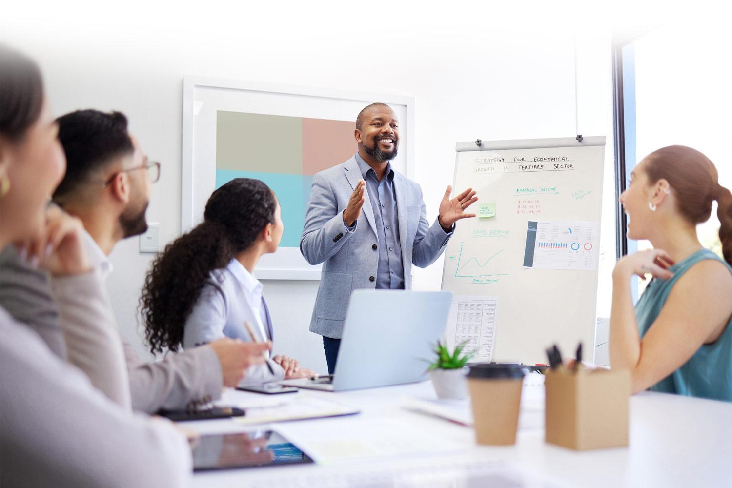 employees listening to a speaker in a meeting room