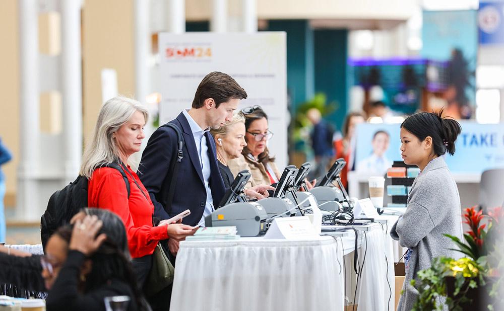 Attendees registering at the welcome desk