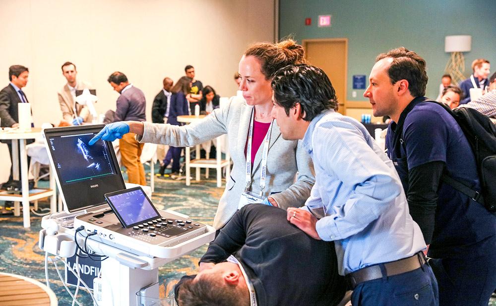 Professionals looking at equipment during a workshop