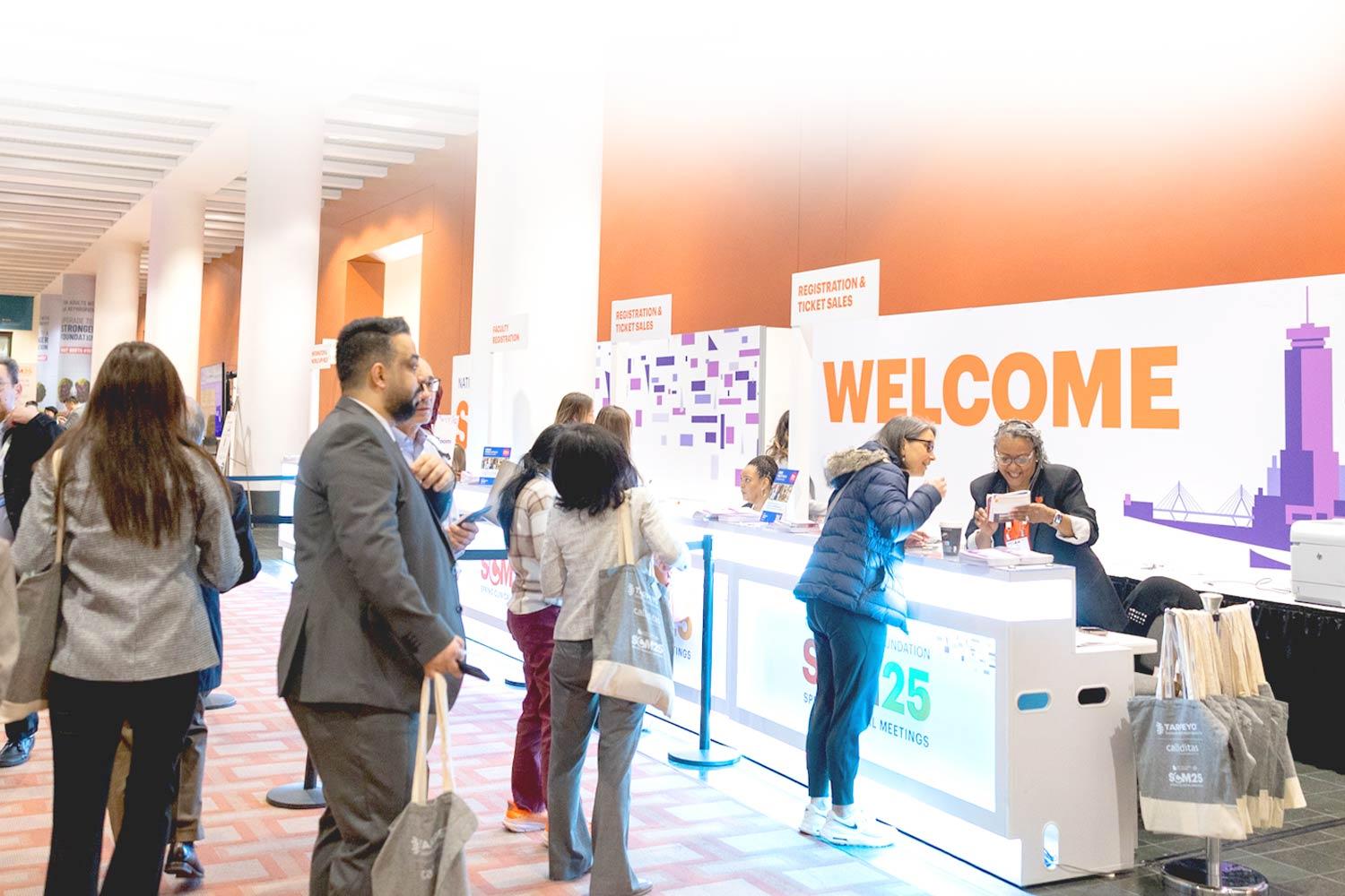 Busy registration desk at SCM25