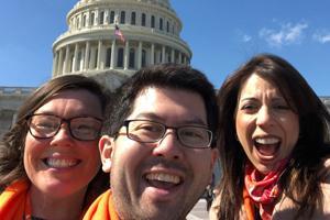 Three advocates cheering at the US capitol