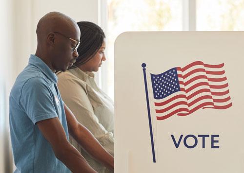 Two people voting at a voting booth