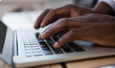 hands typing on laptop