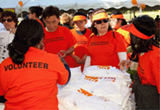 NKF Volunteers at an event wearing "Volunteer" t-shirts