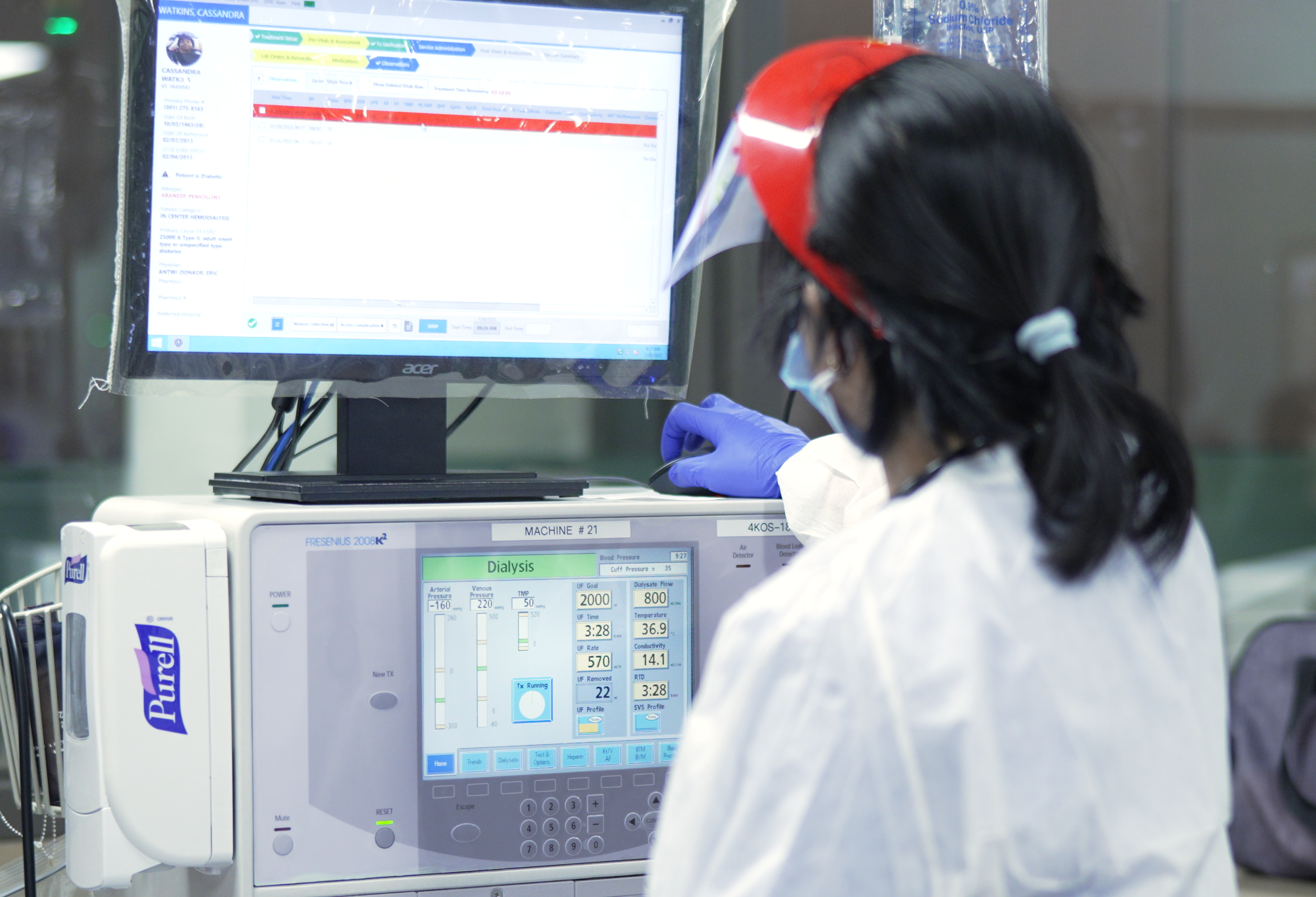 health care professional using a dialysis machine